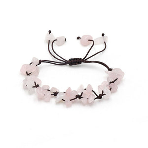 A collection of braided bracelets with various colored crystal stones, displayed on a white surface.