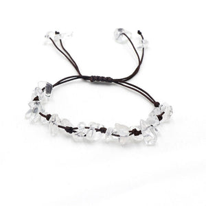A collection of braided bracelets with various colored crystal stones, displayed on a white surface.