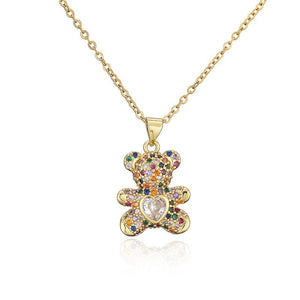 Gold teddy bear pendant necklace with colorful gemstones on a white background
