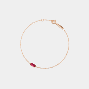 A gold-plated sterling silver bracelet with a single green birthstone charm, on an adjustable chain.