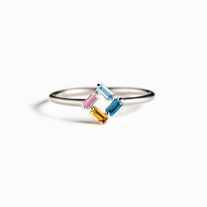 Silver ring with colorful gemstones on a white background