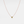 A gold-plated sterling silver necklace with a single red birthstone charm.