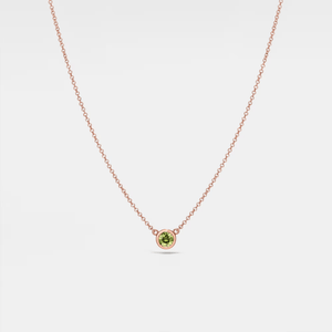 A gold-plated sterling silver necklace with a single red birthstone charm.
