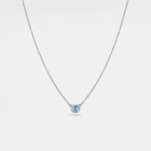 A gold-plated sterling silver necklace with a single red birthstone charm.