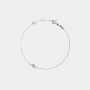 A gold-plated sterling silver bracelet with a single birthstone charm attached to a gold-plated chain.