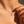 Close-up of a silver necklace with a pendant on a person's neck.