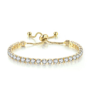 Gold bracelet with clear gemstones on a white background