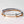 Stack of three bracelets with engraved coordinates on a light background