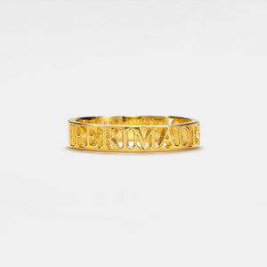 Gold ring with 'PERIMADE' engraving on a white background