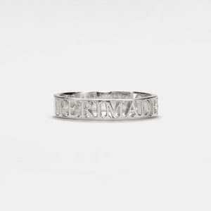 A gold-plated sterling silver band ring with engraved text on it.