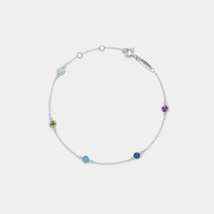 A gold-plated sterling silver bracelet with multiple colored gemstone charms representing different months.