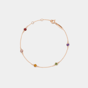 A gold-plated sterling silver bracelet with multiple colored gemstone charms representing different months.