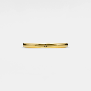 Gold ring with a single letter 'A' on a light gray background