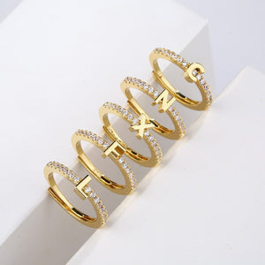 Three gold rings with lettering on a white background