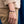 Person wearing a bracelet with charms on a blurred background