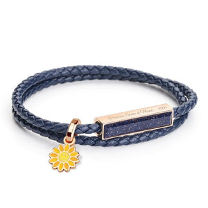 Navy braided bracelet with rose gold clasp and sunflower charm on a white background