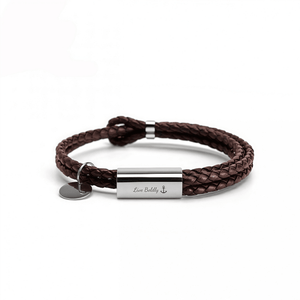 Brown braided leather bracelet with silver tag on a white background