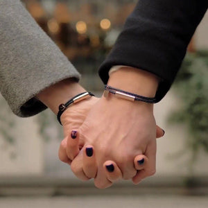Two hands holding each other with blurred background