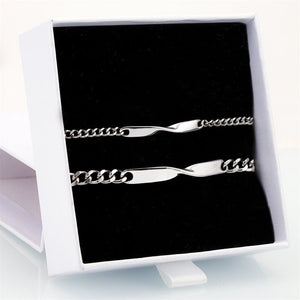 Two silver chain necklaces on a black card inside a white box