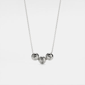 A gold-plated sterling silver pendant necklace with three spherical charms on a chain, displayed against a white background.