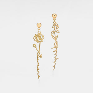 Gold rose-shaped earrings on a light gray background
