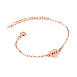 Rose gold bracelet with a heart-shaped name tag on a white background