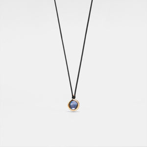 A black rope necklace with a circular silver pendant featuring a photo projection.
