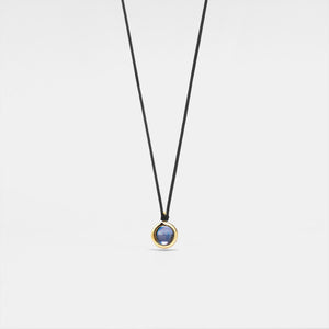 Necklace with a round pendant on a light gray background