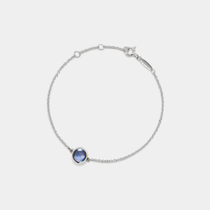 Silver bracelet with a projection gemstone on a light gray background