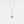 A gold-plated sterling silver charm necklace with a teardrop-shaped pendant featuring a photo projection, suspended from a delicate chain.