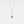 A rose gold-plated sterling silver charm necklace with a teardrop-shaped pendant featuring a photo projection, suspended from a delicate chain.