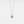 A white gold-plated necklace with a teardrop-shaped charm featuring a projection bead and small clear stones around the edge, on a white background.