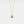 A gold-plated necklace with a teardrop-shaped charm featuring a projection bead and small clear stones around the edge, on a white background.