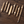 Set of gold pens on a wooden surface