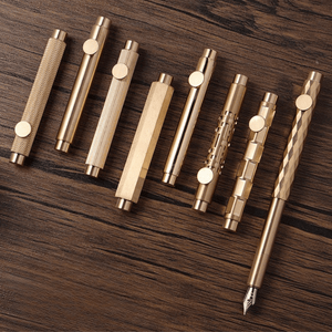 Set of gold pens on a wooden surface