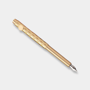Gold fountain pen on a light gray background