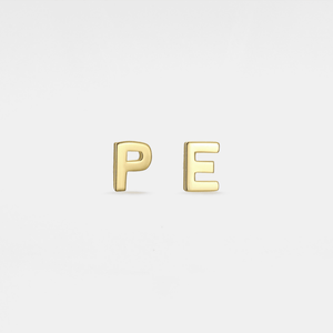 Gold letter 'P' and 'E' earrings on a light gray background