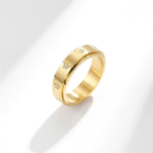 Gold fidget spinner ring with star patterns and cubic zirconia embellishments.