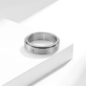 Silver fidget spinner ring with star patterns and cubic zirconia embellishments.