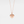 Rose gold heart-shaped locket necklace with a star and diamond on a light gray background