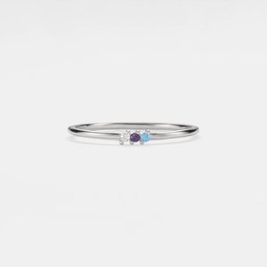 A gold-plated sterling silver ring with a single birthstone cubic zirconia set in a thin band.