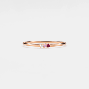 A gold-plated sterling silver ring with a single birthstone cubic zirconia set in a thin band.