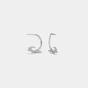 Pair of silver hoop earrings on a light gray background