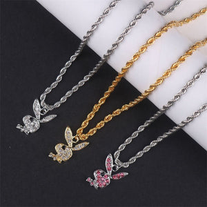 Three necklaces with different bird pendants on a black and white background