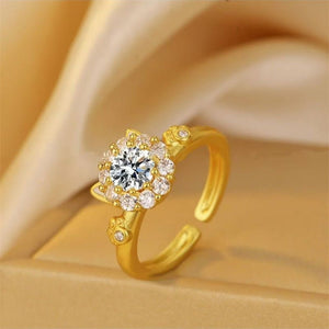 Gold ring with a diamond on a beige background