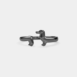 A gold-colored sterling silver ring in the shape of a Dachshund dog.