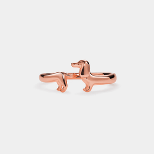 A gold-colored sterling silver ring in the shape of a Dachshund dog.