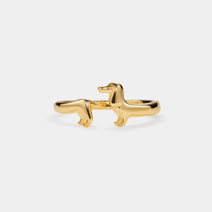Gold dachshund-shaped ring on a white background