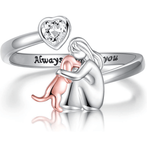 Silver ring with heart-shaped gem and 'Always' engraving, featuring a small figure holding a heart.