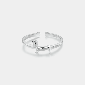 Silver ring with a dachshund dog design on a white background